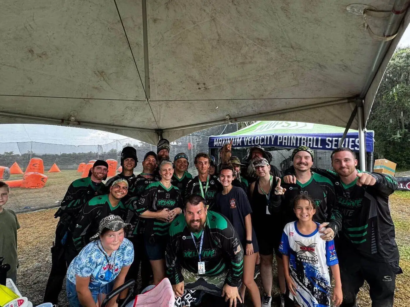 XPlex team and family celebrating together under a tent
